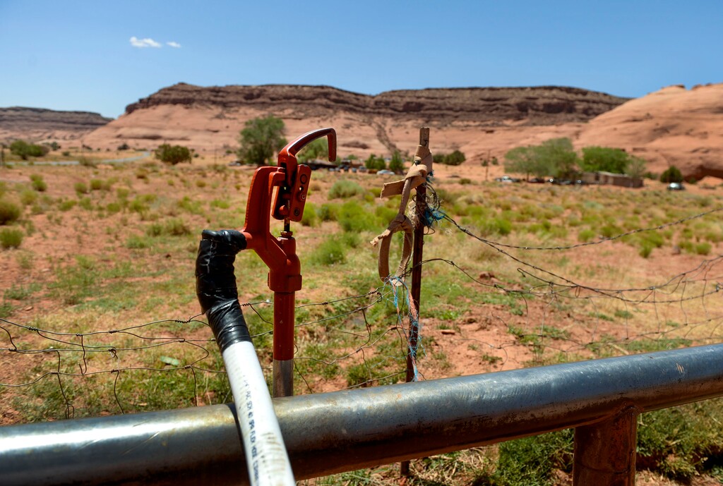 (Leah Hogsten  |  Tribune file photo) The Oljato-Monument Valley water spigot adjacent to the post office is one of a few locations in San Juan County where members of the Navajo Nation can get clean water.