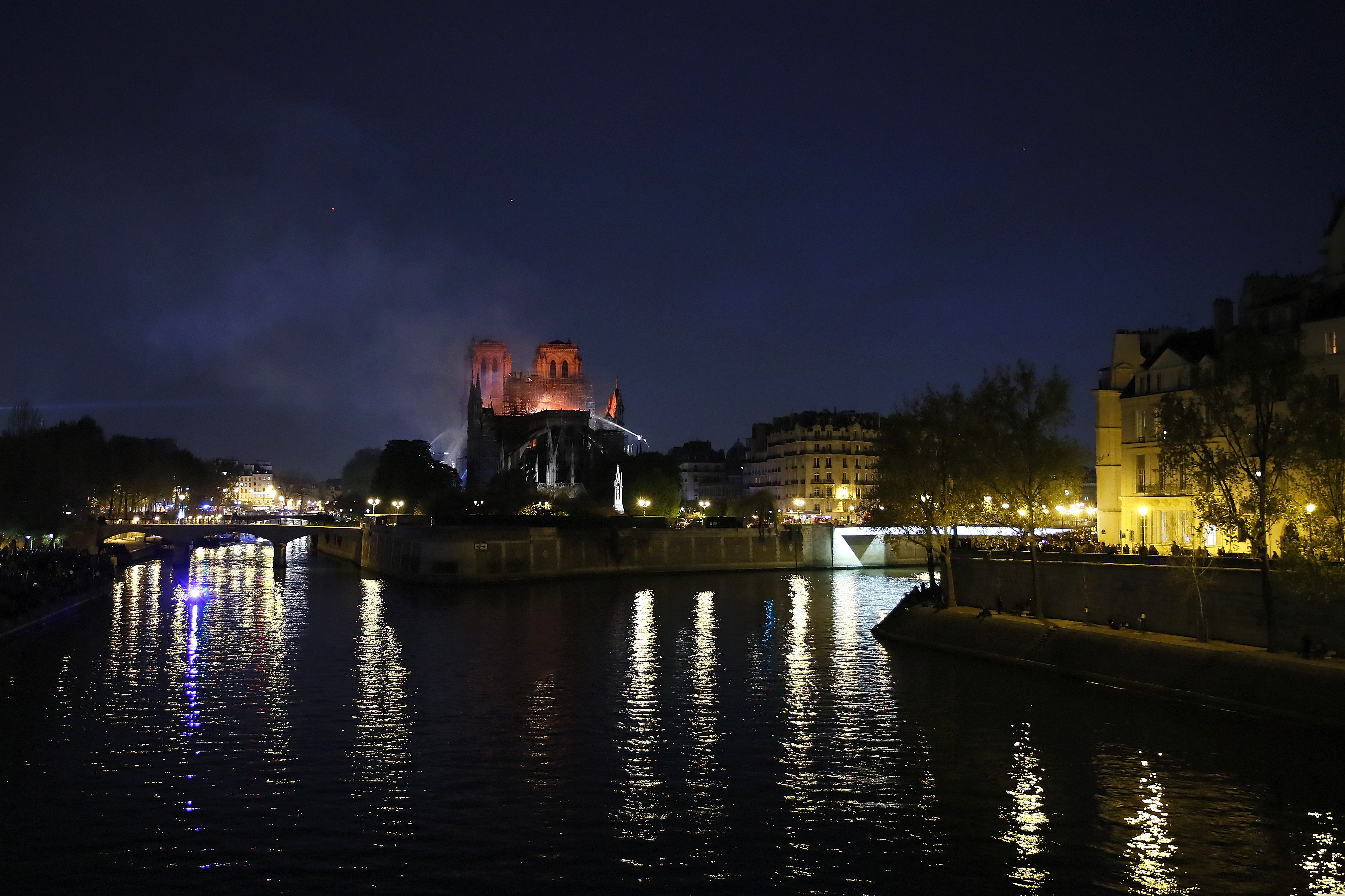 Notre Dame cathedral is seen burning in Paris, Monday, April 15, 2019. A catastrophic fire engulfed the upper reaches of Paris' soaring Notre Dame Cathedral as it was undergoing renovations Monday, threatening one of the greatest architectural treasures of the Western world as tourists and Parisians looked on aghast from the streets below. (AP Photo/Francois Mori)