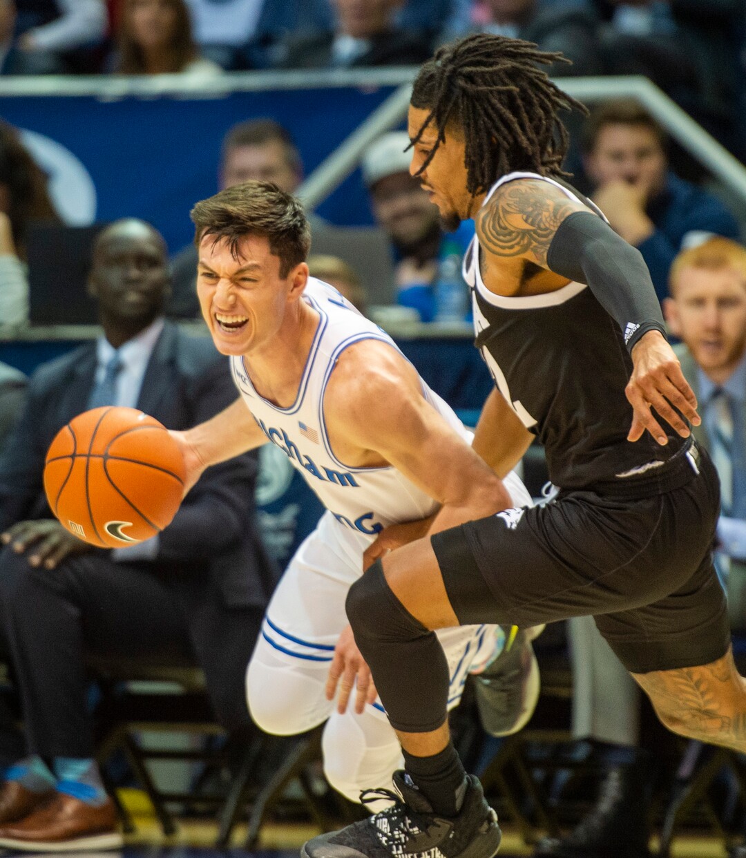 (Rick Egan  |  The Salt Lake Tribune)        Brigham Young Cougars guard Jake Toolson (5) drives inside with the ball, as Nevada Wolf Pack guard Lindsey Drew (14) defends, in basketball action between the Brigham Young Cougars and the Nevada Wolf Pack, at the Marriott Center, in Provo, Saturday, December 10, 2019.