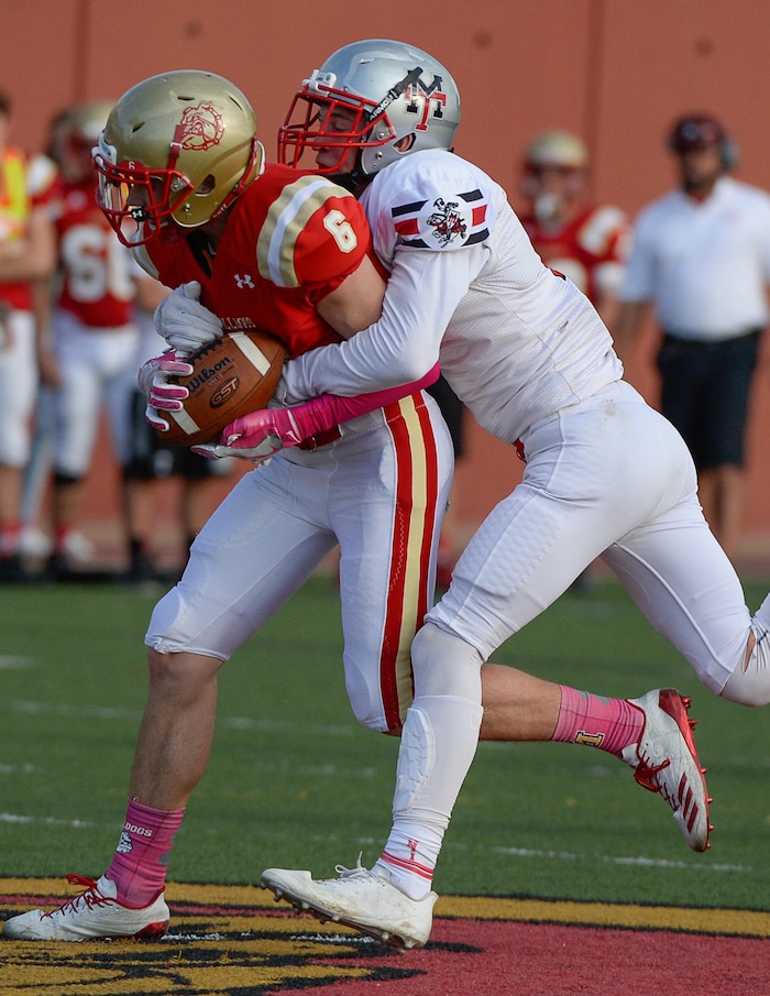 (Francisco Kjolseth  |  The Salt Lake Tribune)  Casey Bouillon of Judge pulls in a pass while pressured by Adam Huff of Manti in the Class 3A football playoff game at Judge Memorial on Thursday, Oct. 19, 2017. 