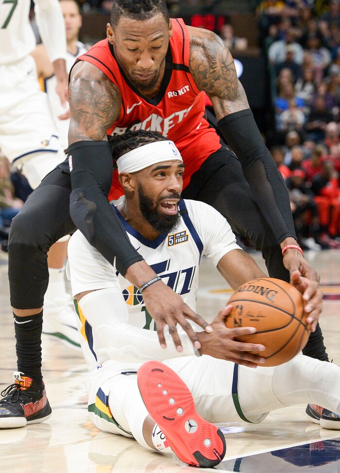 (Leah Hogsten  |  The Salt Lake Tribune)  Utah Jazz guard Mike Conley (10) tries to keep possession from Houston Rockets forward Robert Covington (33). The Utah Jazz host the Houston Rockets at Vivint Arena, Feb. 22, 2020.