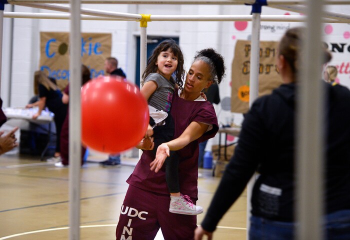(Scott Sommerdorf   |  The Salt Lake Tribune)   Inmate Angela Rekoutis plays with her daughter Ava during "Kids Day" at the Utah State Prison, Saturday, October 7, 2017. 
