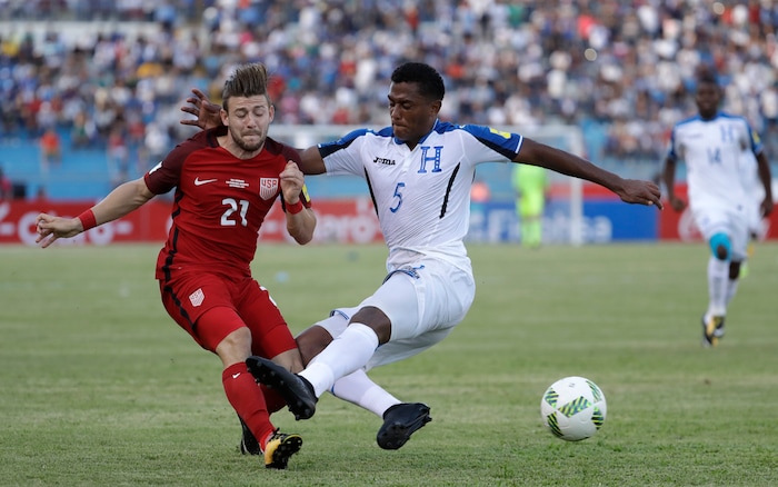 United States' Paul Ariola, left, and Honduras' Ever Alvarado, fight for the ball during a 2018 World Cup qualifying soccer match in San Pedro Sula, Honduras, Tuesday, Sept. 5, 2017. (AP Photo/Rebecca Blackwell)