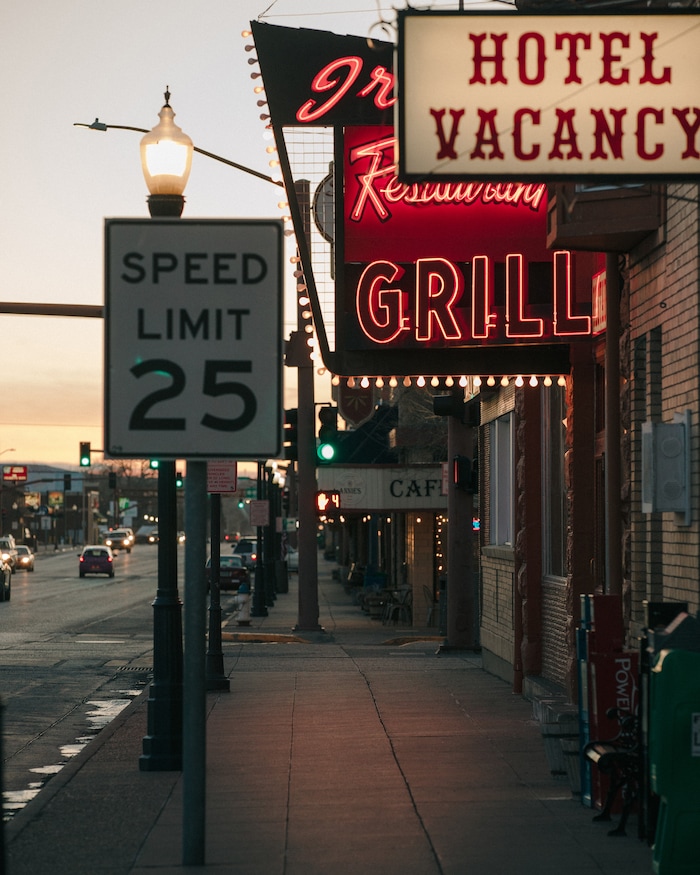 (Elliot Ross | The New York Times) Sunrise on Sheridan Avenue, the main drag of Cody, Wyo., Jan. 28, 2020. The signage for Buffalo Bill's Irma Hotel & Restaurant is among the most prominent in town.