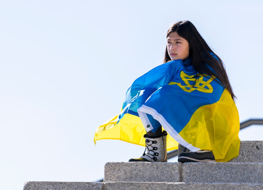 (Rick Egan | The Salt Lake Tribune) Mia Quincanilla sits on the steps of the Capitol, during a rally against Russia's invasion of Ukraine, organized by the Utah Ukrainian association, on Saturday, March 12, 2022.