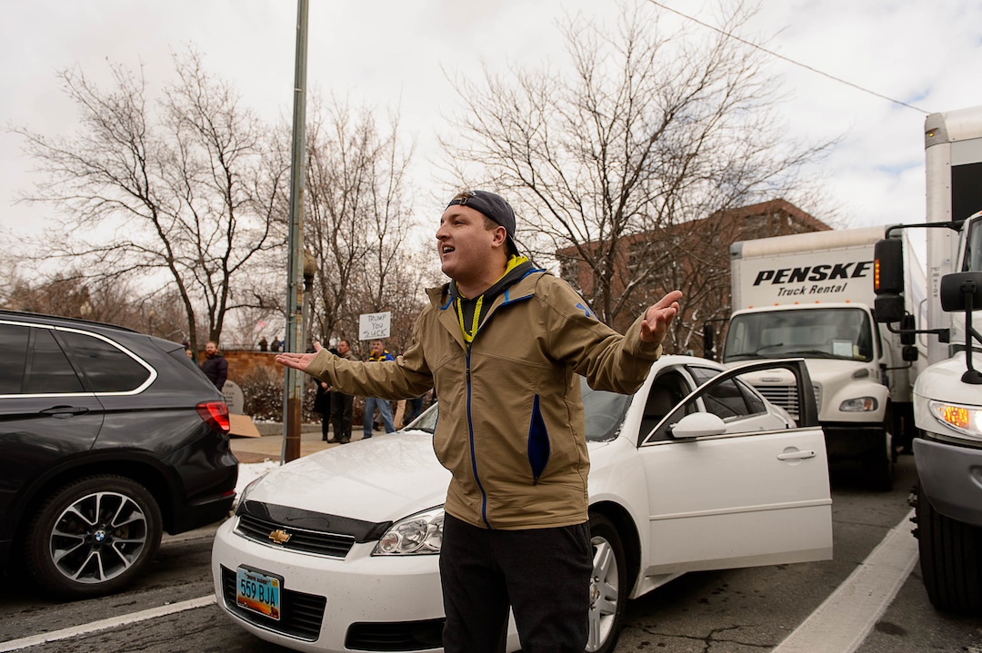(Trent Nelson | The Salt Lake Tribune)  A motorist argues with protesters after they blocked off an intersection after a rally against a visit by President Donald Trump, Monday December 4, 2017.
