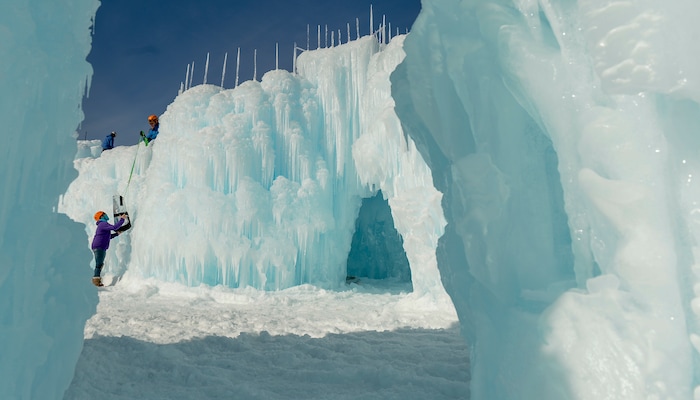 Leah Hogsten | The Salt Lake Tribune Sara Juvenal hands equipment to fellow worker on the Ice Castle installation, Friday, Jan. 4, 2019. The idea started with a backyard castle in Alpine followed by an ice castle in downtown Midway in 2009. Ice Castles is open for the winter Saturday, Jan. 5, at Homestead Resort. This is the ninth season the popular frozen art installation is drawing visitors to walk around the giant LED-lit icicle formations.