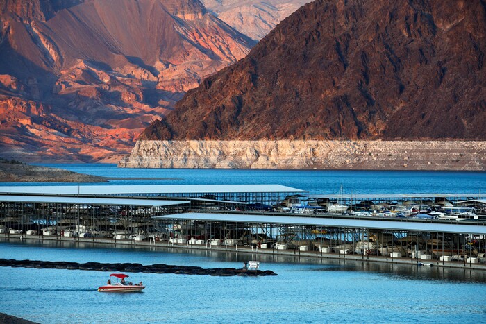 FILE - In this July 18, 2014 file photo, the bathtub ring of light minerals that delineates the high water mark on Lake Mead is seen at Hemenway Harbor in the Lake Mead National Recreation Area in Nevada. Hawaii residents and an organization representing federal workers filed a lawsuit against the Federal Aviation Administration on Wednesday, Oct. 4, 2017 seeking to force it to do something about tour helicopters buzzing around seven national parks across the country. (AP Photo/John Locher, File)