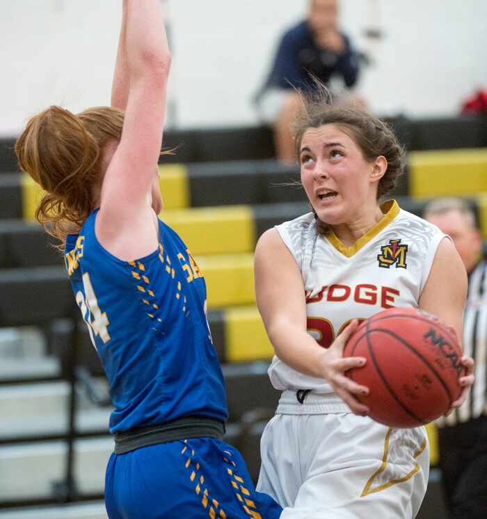 (Rick Egan  |  The Salt Lake Tribune)    San Juan forward, Delaney Palmer, (34) defends as Abbey Storms (20), Judge Memorial takes the ball up the middle, in 3A Women's basketball playoff action Judge Memorial vs. San Juan, in Heber City,  Friday, Feb. 16, 2018.