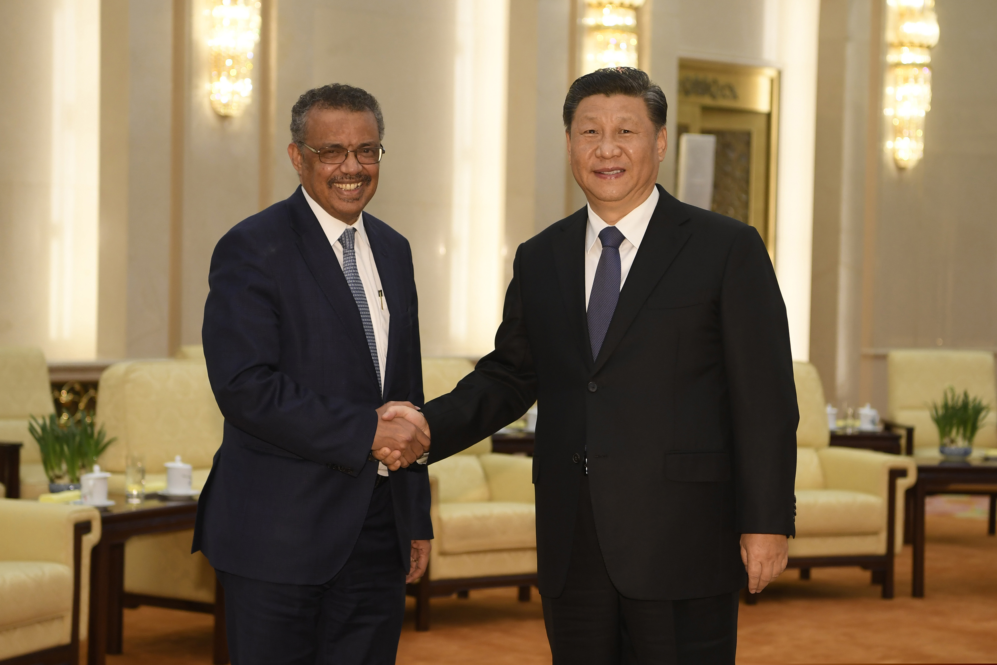 (Naohiko Hatta | AP file photo)  In this Jan. 28 photo, Tedros Adhanom Ghebreyesus, director general of the World Health Organization, left, shakes hands with Chinese President Xi Jinping before a meeting at the Great Hall of the People in Beijing. Throughout January, the World Health Organization publicly praised China for what it called a speedy response to the new coronavirus. It repeatedly thanked the Chinese government for sharing the genetic map of the virus “immediately” and said its work and commitment to transparency were “very impressive, and beyond words.” But behind the scenes, there were significant delays by China and considerable frustration among WHO officials over the lack of outbreak data, The Associated Press has found.