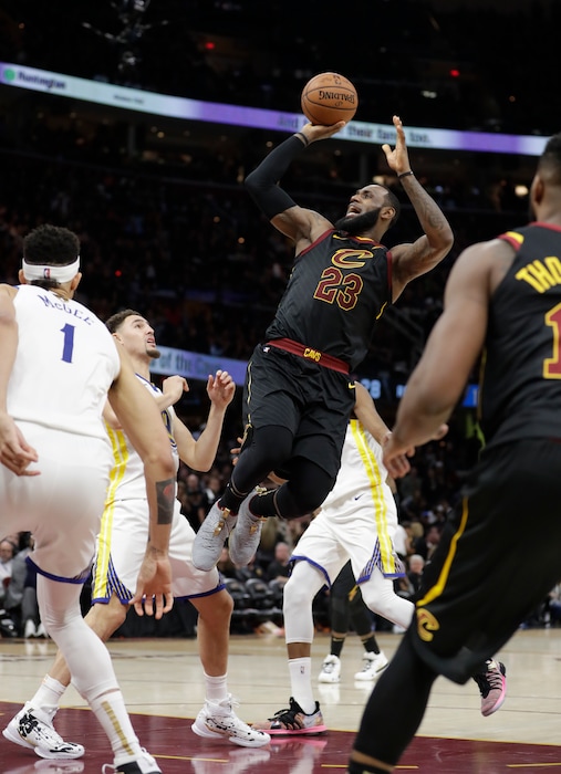 FILE - In this June 6, 2018, file photo, Cleveland Cavaliers' LeBron James shoots in the second half of Game 3 of basketball's NBA Finals against the Golden State Warriors, in Cleveland. With the trajectory of their franchise riding on what he decides to do in the next few weeks, the Cavaliers will enter this year’s draft not knowing if they’re choosing a player to help them _ and James _ contend again for a championship, develop for the future or potentially package in a trade. (AP Photo/Tony Dejak, File)