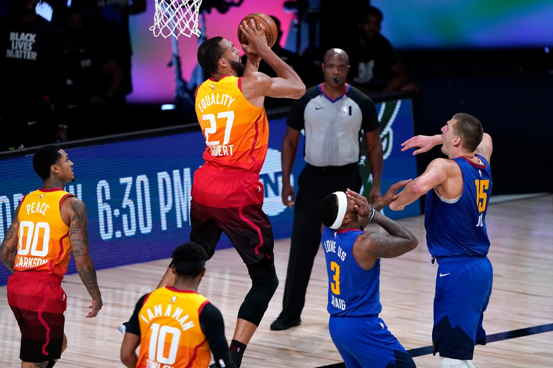 Denver Nuggets' Torrey Craig (3) reacts after being hit in the face by Utah Jazz's Rudy Gobert's (27) elbow during the second half of an NBA basketball first round playoff game Sunday, Aug. 30, 2020, in Lake Buena Vista, Fla. (AP Photo/Ashley Landis)