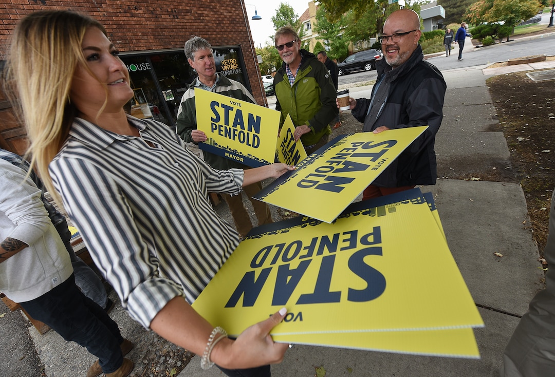 (Francisco Kjolseth  |  The Salt Lake Tribune)  Emily Young hands out signs to supporters as former Salt Lake City Councilman Stan Penfold gets ready to announce his bid for mayor in the 9th East and 9th South area of Salt Lake City on Thursday, Oct. 4, 2018.