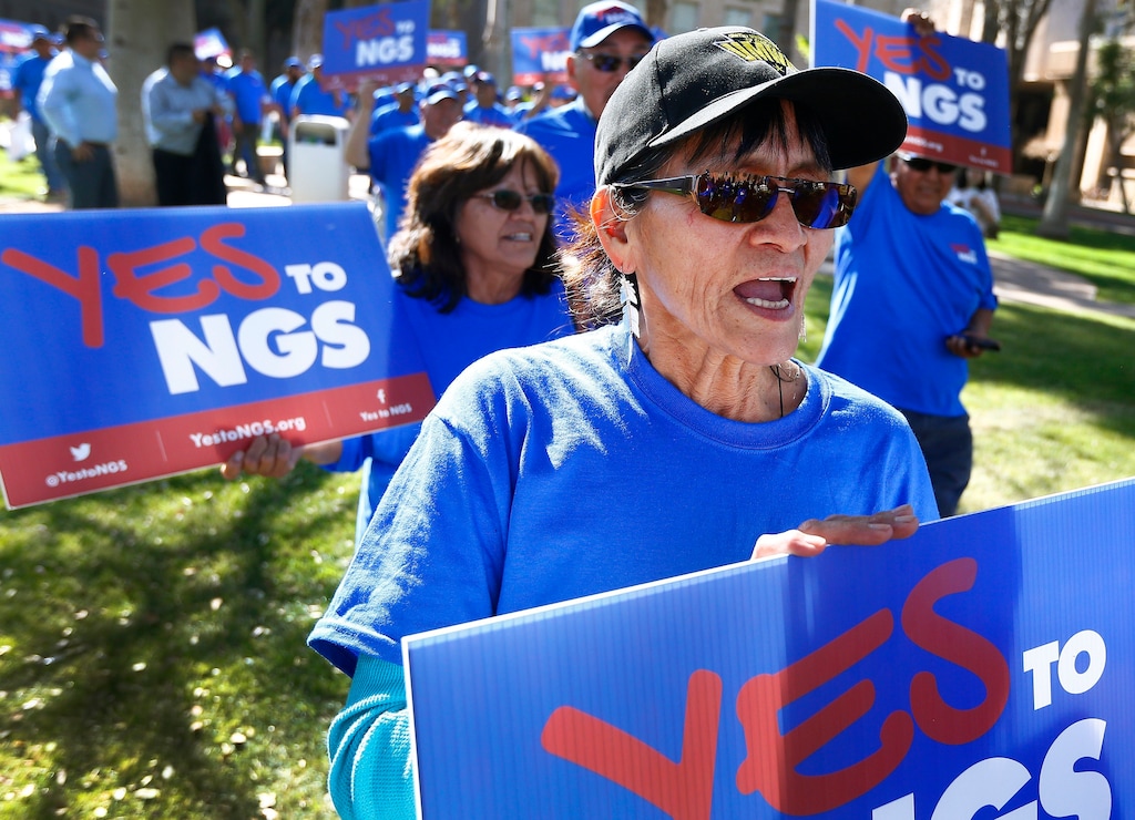 (Ross D. Franklin | The Associated Press) A coalition of groups march during a rally to build support for extending the life of the Navajo Generating Station power plant near the Arizona-Utah border, at the Arizona Capitol Tuesday, Feb. 6, 2018, in Phoenix.