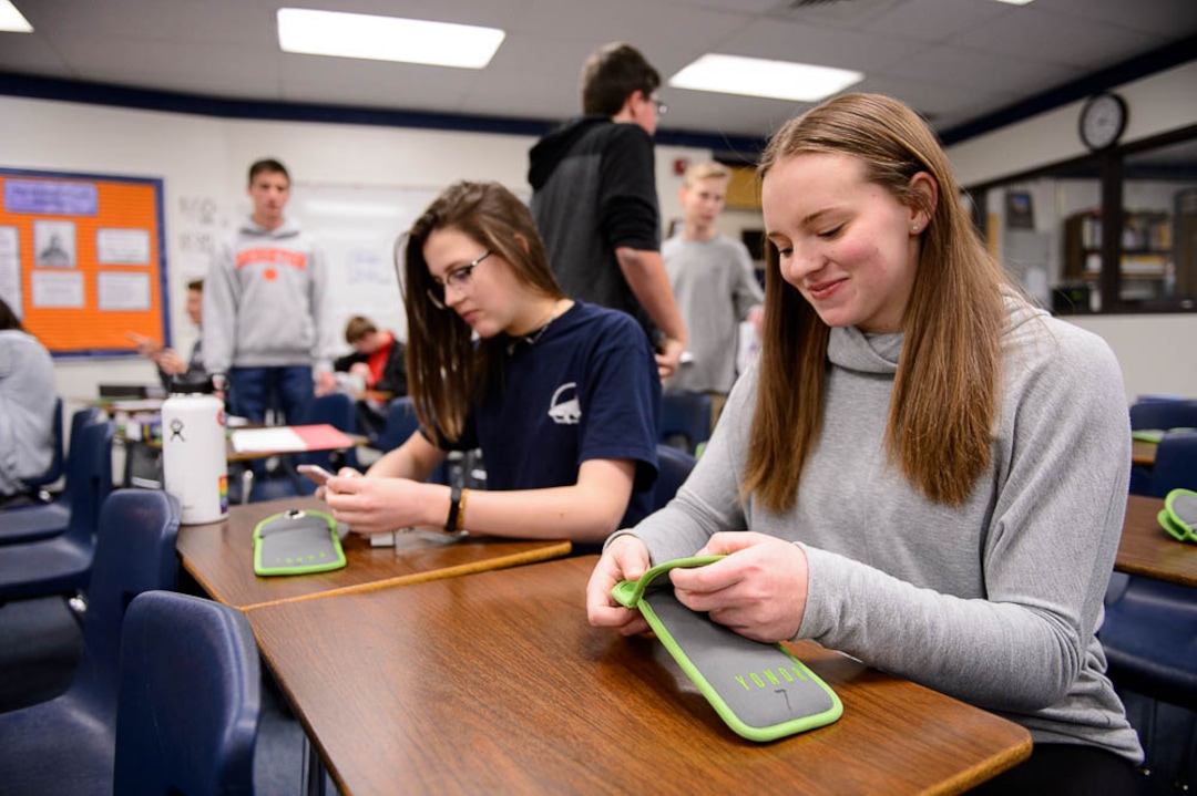 (Trent Nelson | The Salt Lake Tribune) Aydin Smith and Sammi Snyder, students in one of Monta Thomas' classes at Brighton High School in Cottonwood Heights, secure their phones in locking pouches made by Yondr.