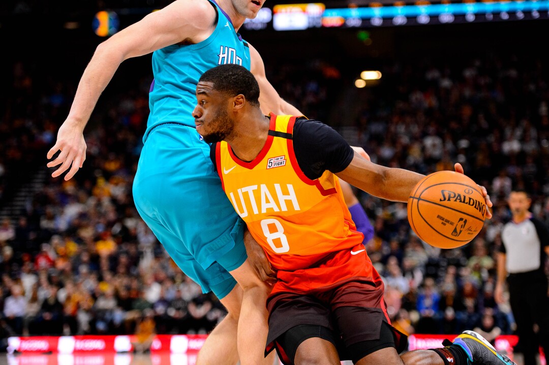 (Trent Nelson  |  The Salt Lake Tribune) Utah Jazz guard Emmanuel Mudiay (8) drives on Charlotte Hornets forward Cody Zeller (40) as the Utah Jazz host the Charlotte Hornets, NBA basketball in Salt Lake City on Friday, Jan. 10, 2020.