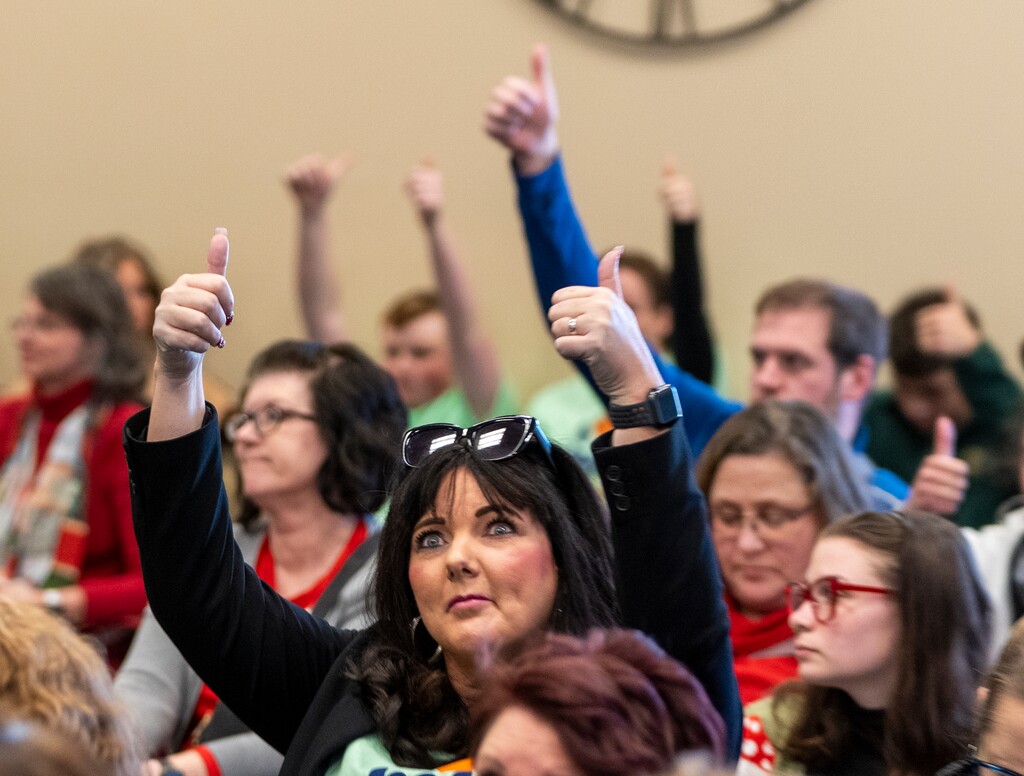 (Rick Egan | The Salt Lake Tribune)  People give a thumbs up sign as they agree with one of the speakers during the Senate Education Committee public comments about HB215, on Monday, Jan. 23, 2023.