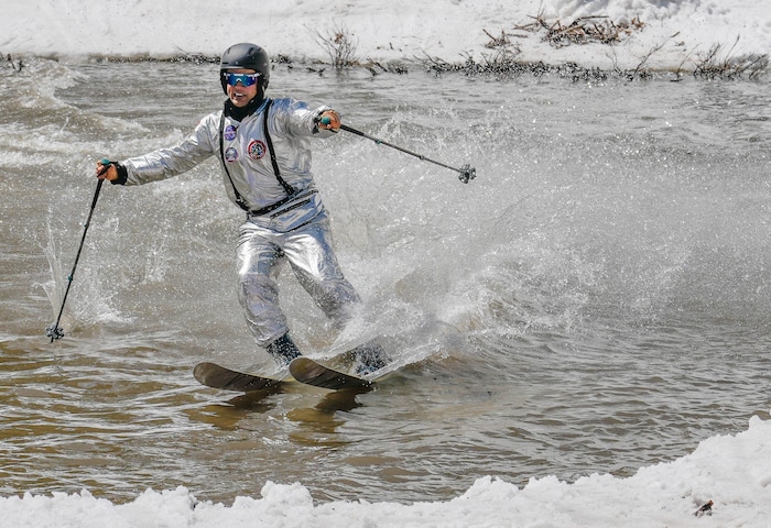 (Francisco Kjolseth  | The Salt Lake Tribune) Jon Fay of Alta wears a NASA suit as he skims across the pond in Peruvian Gulch as Snowbird closes the book on the 2024-25 ski season on Monday, May 26, 2025. Snow and sun revelers took to the slushy slopes on Memorial Day as the resort was the last in the state to close.