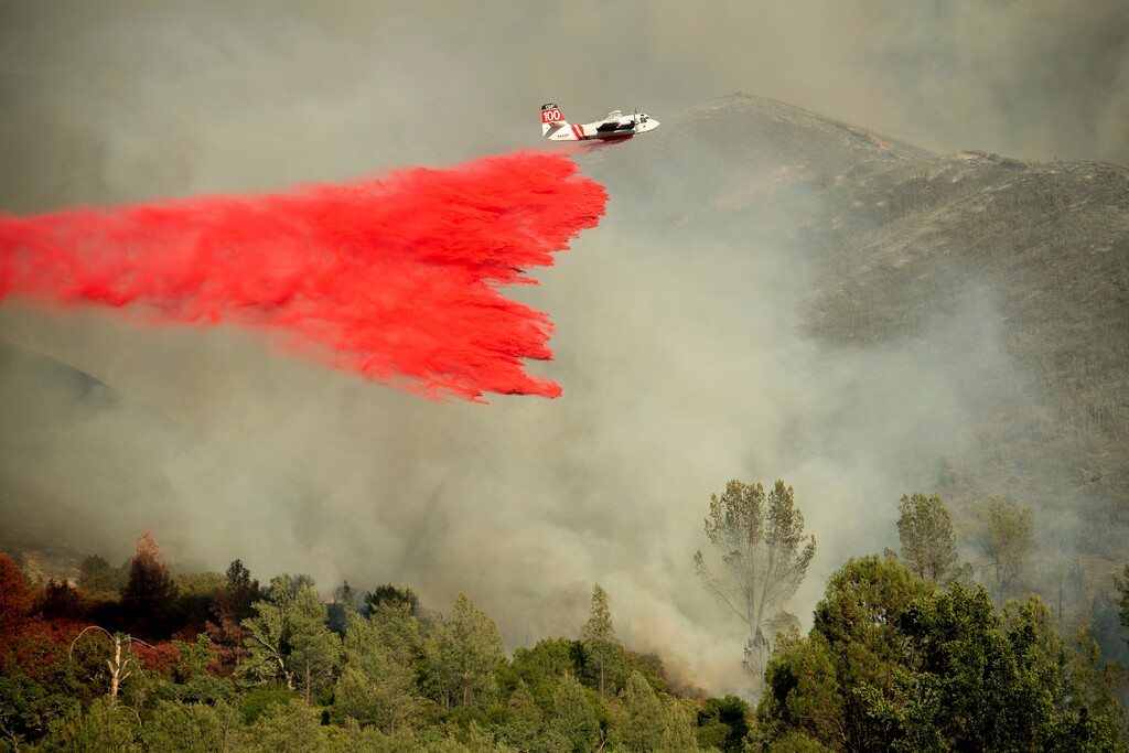 (Noah Berger | AP file photo)
An air tanker drops retardant on a wildfire burning above the Spring Lakes community near Clearlake Oaks, Calif., in June 2018. California regulators on Tuesday. Dec.31, 2019, said that they have streamlined the state's permit process to make it faster to approve tree-thinning projects designed to slow massive wildfires that have devastated communities in recent years.