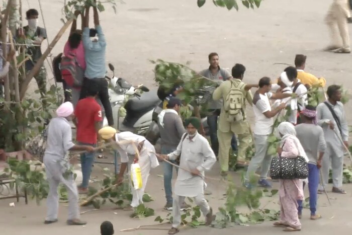 In this image made from video, supporters of an Indian guru who calls himself Saint Dr. Gurmeet Ram Rahim Singh Ji Insaan react after his verdict was announced in Panchkula, India, Friday, Aug. 25, 2017. A north Indian court convicted the flamboyant leader of a quasi-religious sect of raping two of his followers, prompting thousands of supporters to shout angry protests and attack journalists covering Friday's verdict. (AP Photo)