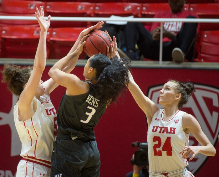 (Rick Egan  |  The Salt Lake Tribune)       Washington Huskies forward Mai-Loni Henson (3) takes a shot, as Utah Utes center Megan Huff (5) and Ute guard/forward Tilar Clark (24), defend, in PAC-12 women's basketball action at the Jon M. Huntsman Center, Sunday, Feb. 18, 2018.