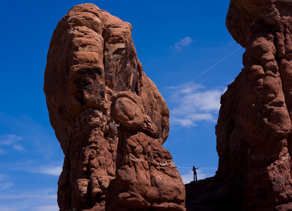 (Bethany Baker  |  The Salt Lake Tribune) A tourist visits the Garden of Eden area inside Arches National Park near Moab on Thursday, April 9, 2026.