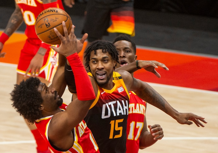 (Rick Egan | The Salt Lake Tribune). Utah center Derrick Favors (15) goes for a rebound along with Atlanta Hawks forward Solomon Hill (18) in NBA action between the Utah Jazz and the Atlanta Hawks at Vivint Arena, on Friday, Jan. 15, 2021.,