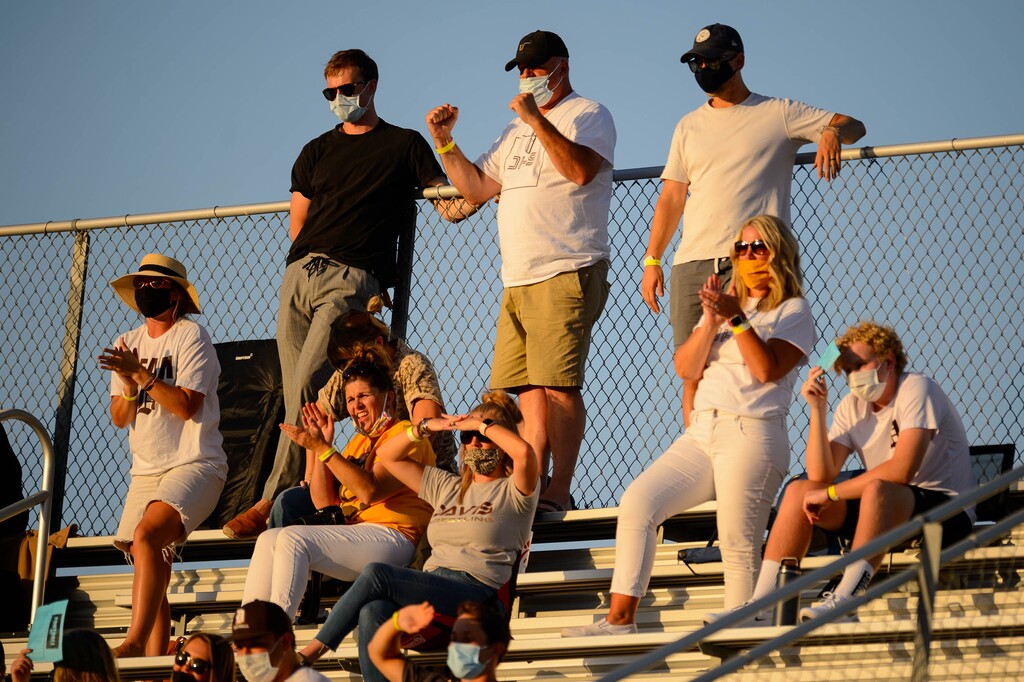 (Trent Nelson  |  Tribune file photo) Masked Davis fans look on as Herriman hosts Davis High School football, in Herriman on Thursday, Aug. 13, 2020.