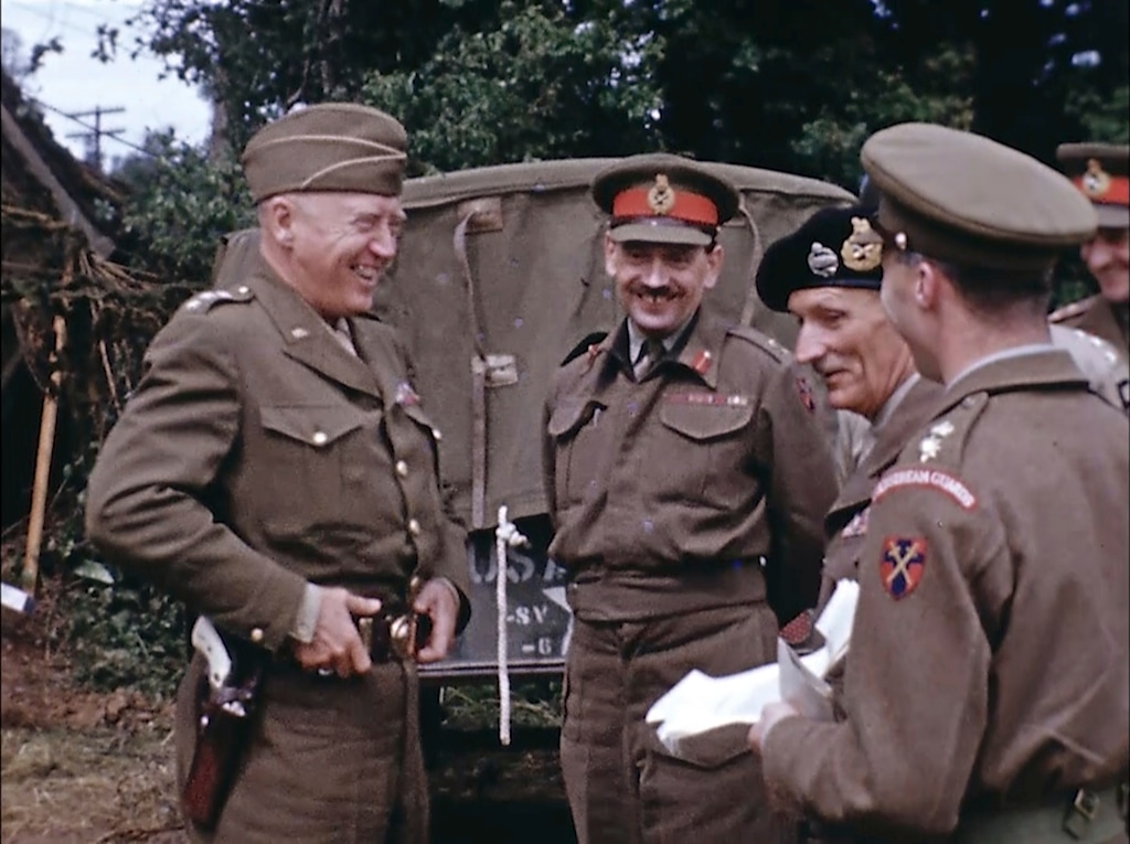 Gen. George Patton, with a pearl-handled pistol, talks to French officers in France during World War II. Seventy-five years later, surprising color images of the D-Day invasion and aftermath bring an immediacy to wartime memories. They were filmed by Hollywood director George Stevens and rediscovered years after his death. (War Footage From the George Stevens Collection at the Library of Congress via AP)