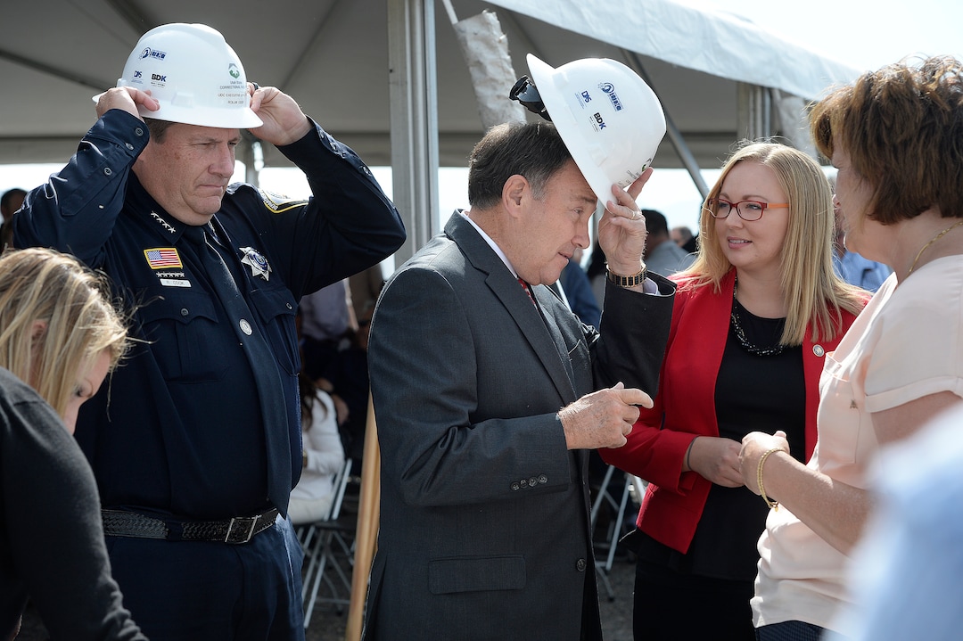 (Scott Sommerdorf   |  The Salt Lake Tribune)   Rollin Cook, left, Exec. Director of Utah Dept. of Corrections, and Utah Governor Gary Herbert, try on their hard hats prior to using their shovels to turn some dirt a the site of the new prison, Wednesday, August 16, 2017. 