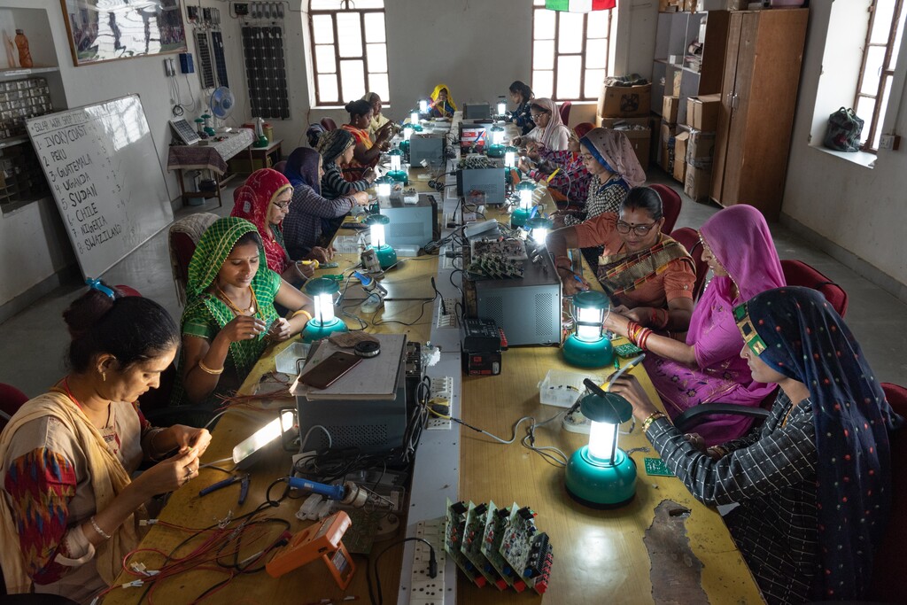 (Smita Sharma | The New York Times)

Women from villages near Tilonia, India learn how to make solar lamps at the Barefoot College, March 20, 2023.