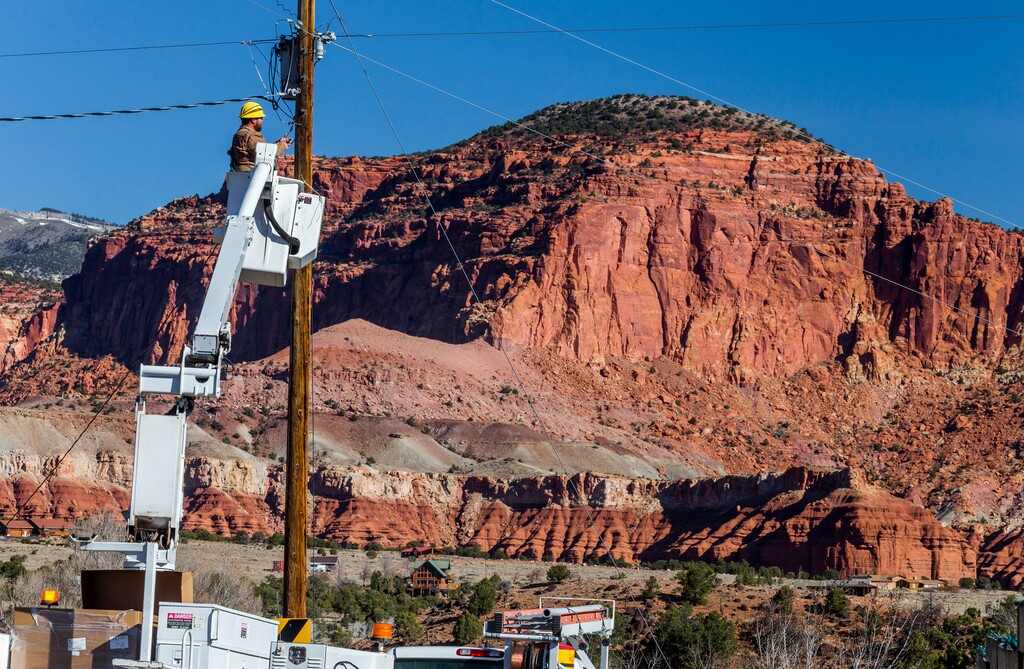 Scott T. Smith  |  CourtesyGarkane Energy lineman Courney Cropper installs new dark sky friendly LED streetlight in Torrey, Utah. USA.