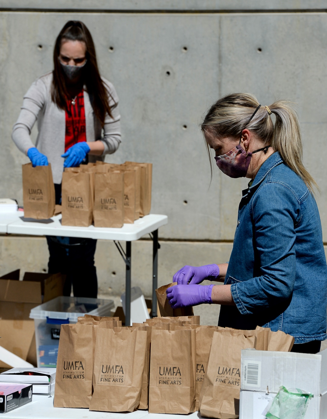 (Francisco Kjolseth  |  The Salt Lake Tribune) The UMFA learning engagement team members Katie Seastrand, left, and Ashley Farmer assemble "UMFA Art Kits," to provide art supplies to high school students to help them complete end-of-year course work. The volunteers filled 1,500 kits with colored pencils, postcards and art activities on Friday, May 4, 2020, to help kids in the Granite School District and Whitehorse High School in San Juan County, to finish school projects and get excited about home projects during the coronavirus pandemic.