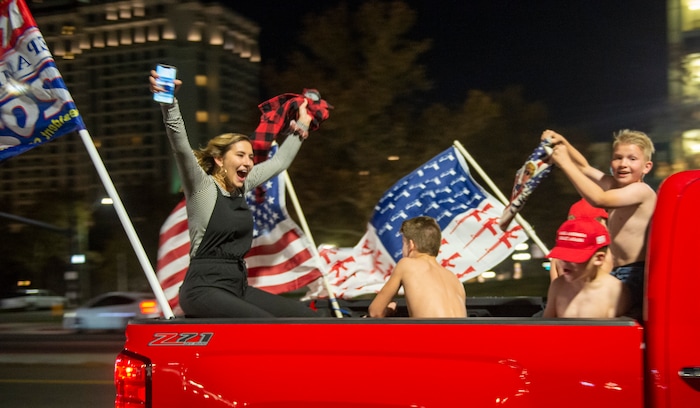 (Rick Egan | The Salt Lake Tribune) Trump supporters scream and yell from the back of a pick-up truck on State Street on Monday, Nov. 2, 2020.