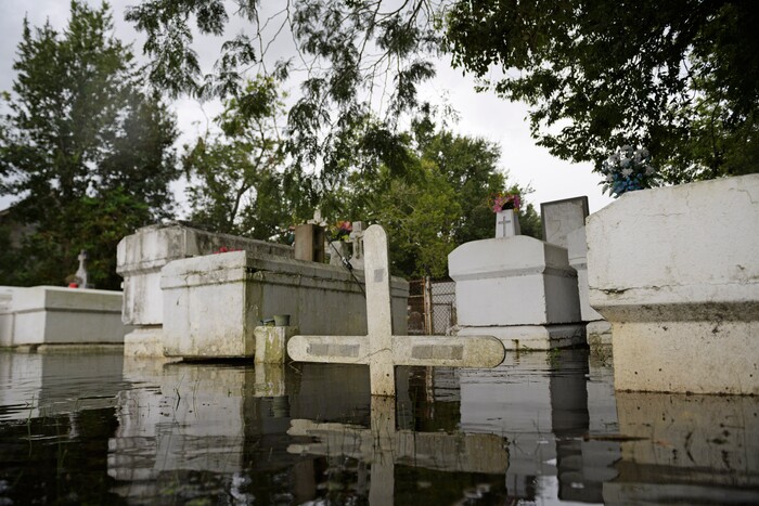 A cemetery along Privateer Blvd. in Barataria, La. is inundated in water as water levels surge before Hurricane Laura, Wednesday, Aug. 26, 2020 in Barataria, La. (Max Becherer/The Advocate via AP)