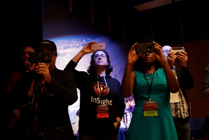 (Marcio Jose Sanchez | The Associated Press) Members of the media take photos as the InSight lander prepares to land on Mars' surface at NASA's Jet Propulsion Laboratory Monday, Nov. 26, 2018, in Pasadena, Calif.