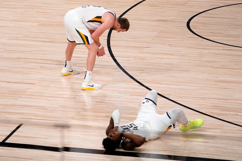 Utah Jazz's Joe Ingles (2) and Donovan Mitchell, bottom right, sit on the floor after their 80-78 loss to the Denver Nuggets during an NBA first round playoff basketball game, Tuesday, Sept. 1,2020, in Lake Buena Vista, Fla. (AP Photo/Mark J. Terrill)