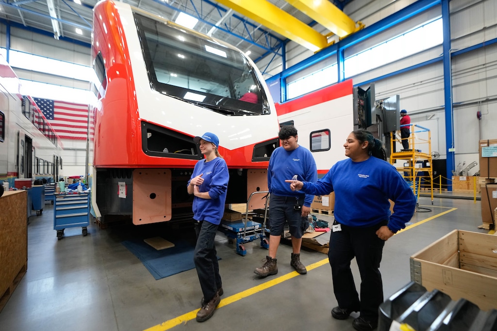 (Francisco Kjolseth | The Salt Lake Tribune) Gracen Whitelock, 17, Alejandro Mauricio, 18, and Fatima Ramirez, 17, from left, talk about their work at Stadler in Salt Lake City on Wednesday, May 10, 2023. The train manufacturing company offers an apprenticeship program, which is hybrid of work and school for high schoolers and Salt Lake Community College students.