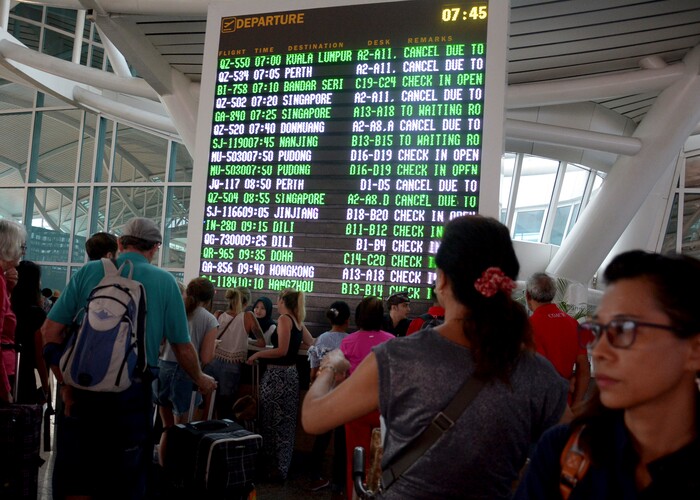(Ketut Nataan | The Associated Press) A flight information board shows cancelled flights at Ngurah Rai International Airport in Bali, Indonesia, Monday, Nov. 27, 2017. Indonesian authorities raised the alert for a rumbling volcano on Bali to the highest level on Monday, stranding tens of thousands of travelers as ash clouds forced the closure of the tourist island's international airport.