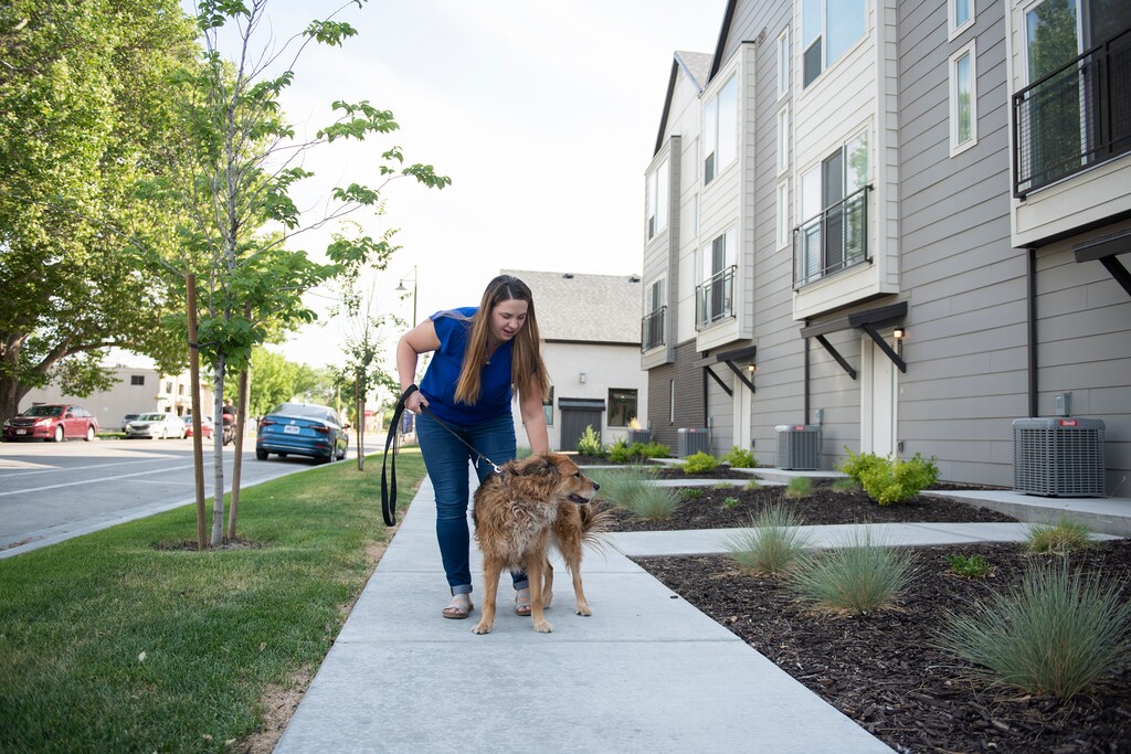 (Briana Scroggins | Special to The Tribune) Kristen Taylor walks her dog, Kara, outside of their apartment in South Salt Lake on Wednesday, June 16, 2021. Her landlord recently paid for a DNA test for Kara. More housing complexes are requiring such tests to prevent pet-owning tenants from leaving droppings on the property — or to bust them when they do.
