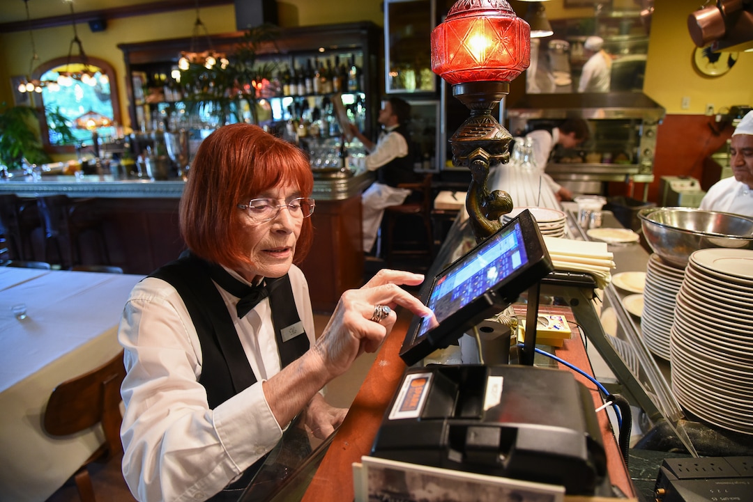 (Francisco Kjolseth  |  The Salt Lake Tribune)  Flo Blank, who has been a restaurant server for nearly 40 years, previously working in NYC, and at Salt Lake City's La Parisian and Al Forno's, works her regular shift at The Paris Restaurant at 15th and 15th in Salt Lake recently as she inputs an order for a large table recently.