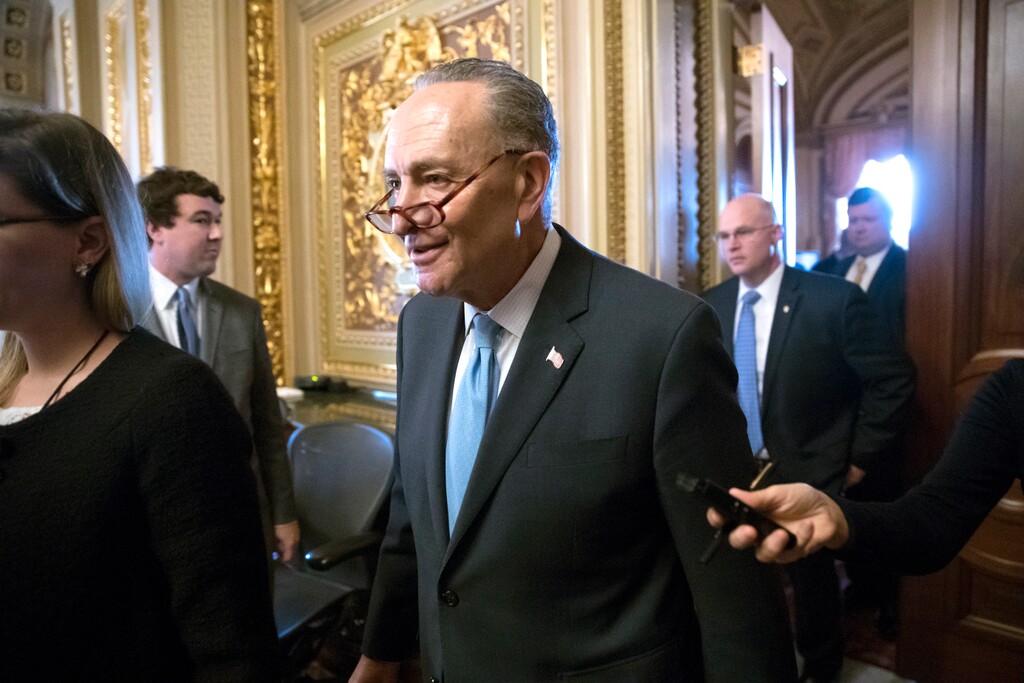 Senate Minority Leader Chuck Schumer, D-N.Y., heads to the chamber with fellow Democrats for a procedural vote aimed at reopening the government, at the Capitol in Washington, Monday, Jan. 22, 2018. (AP Photo/J. Scott Applewhite)