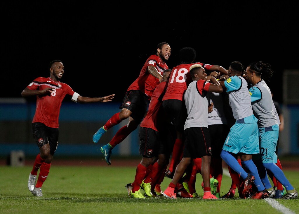 Trinidad and Tobago players celebrate after scoring their second goal against the U.S. at their World Cup qualifying match at Ato Boldon Stadium in Couva, Trinidad and Tobago, Tuesday, Oct. 10, 2017. (AP Photo/Rebecca Blackwell)