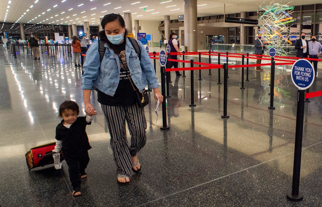 (Rick Egan  |  The Salt Lake Tribune)    Danny Fafita pulls his luggage as he walks with his mother Fafita on the first day of the new terminal at the Salt Lake City International Airport on Tuesday, Sept. 15, 2020.
