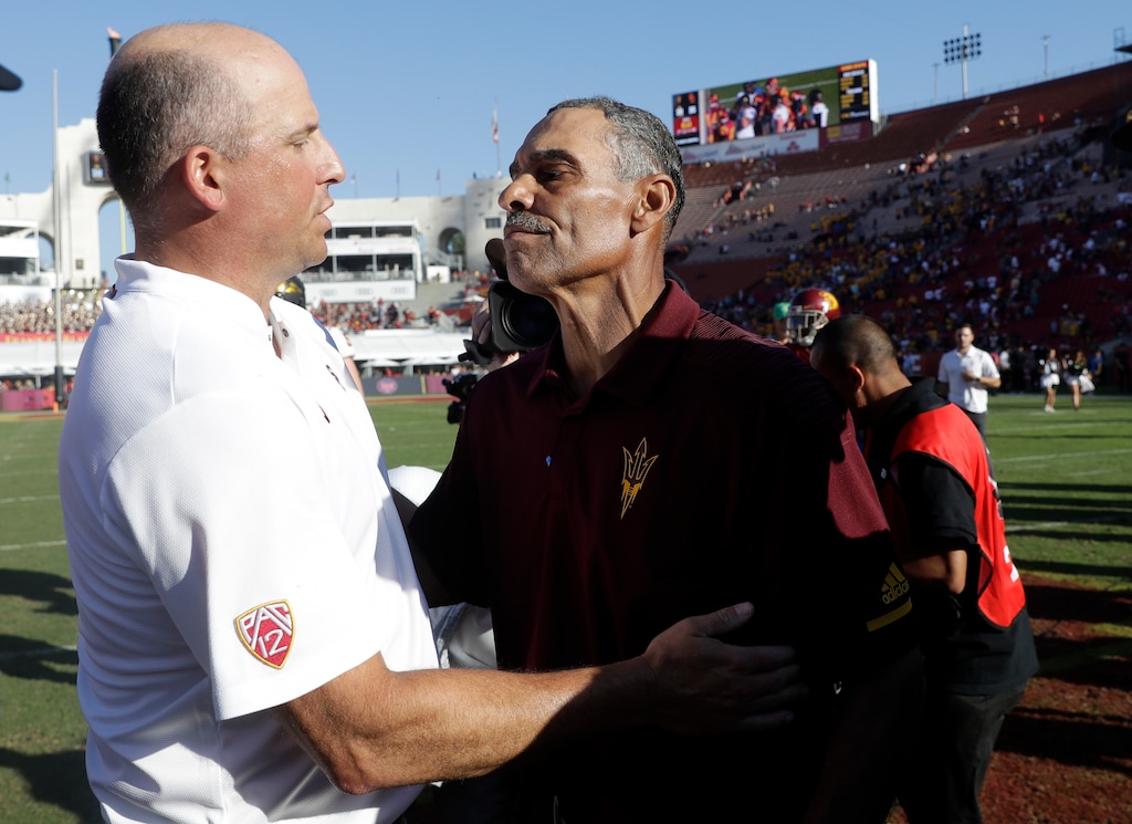 Arizona State head coach Herm Edwards, right, shakes hands with Southern California head coach Clay Helton after Arizona State's 38-35 win during an NCAA college football game Saturday, Oct. 27, 2018, in Los Angeles. (AP Photo/Marcio Jose Sanchez)
