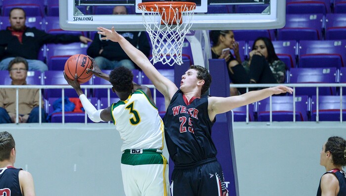 (Leah Hogsten  |  The Salt Lake Tribune) Kearns' David Andrew (03) rounds Weber's Kobe Furqueron (25) to hit the net. Weber defeated Kearns 60-52 in the 6A High School Boys' Basketball Tournament opening game at Weber State University’s Dee Events Center in Ogden, Tuesday, Feb. 27, 2018. 