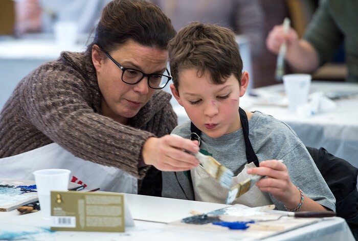 (Leah Hogsten  |  The Salt Lake Tribune) Lori Block, left, gives her son Quinton, 10, a helping hand with his paint brush during their Bob Ross Paint-Along class, Saturday, Jan. 6, 2018, at the Salt Lake City Public Library's Sweet Branch in the Avenues.