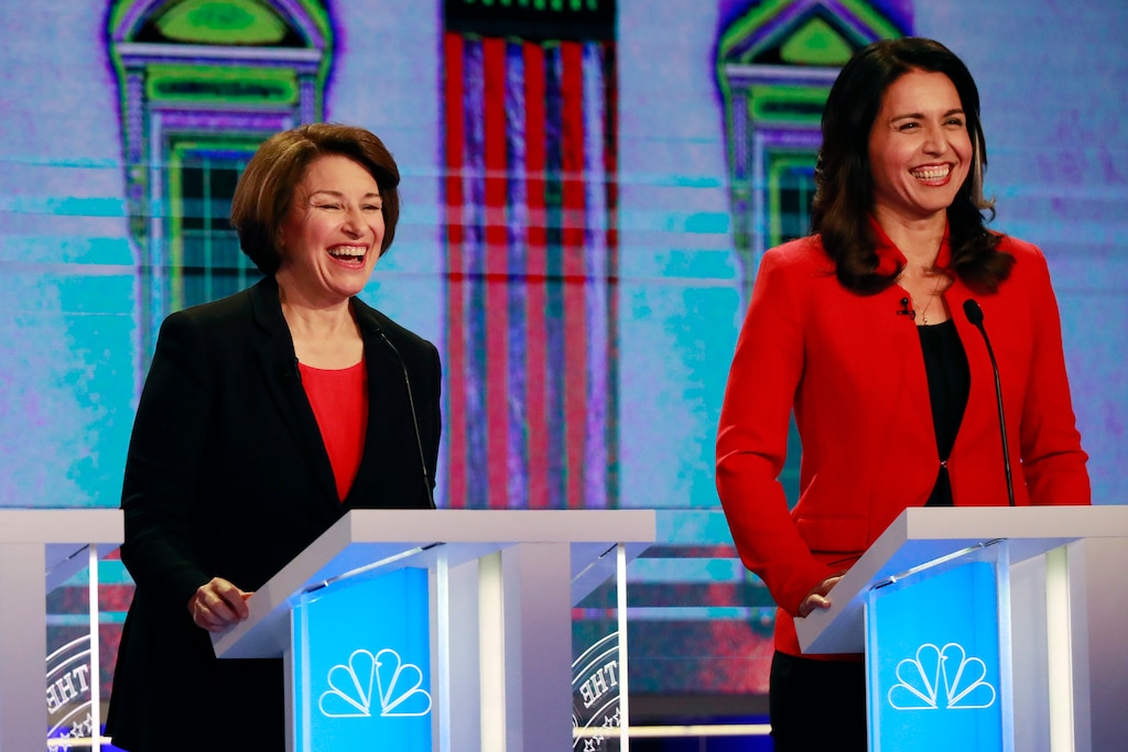 Democratic presidential candidates Sen. Amy Klobuchar, D-Minn., and Rep. Tulsi Gabbard, D-Hawaii, smile during a Democratic primary debate hosted by NBC News at the Adrienne Arsht Center for the Performing Arts, Wednesday, June 26, 2019, in Miami. (AP Photo/Wilfredo Lee)
