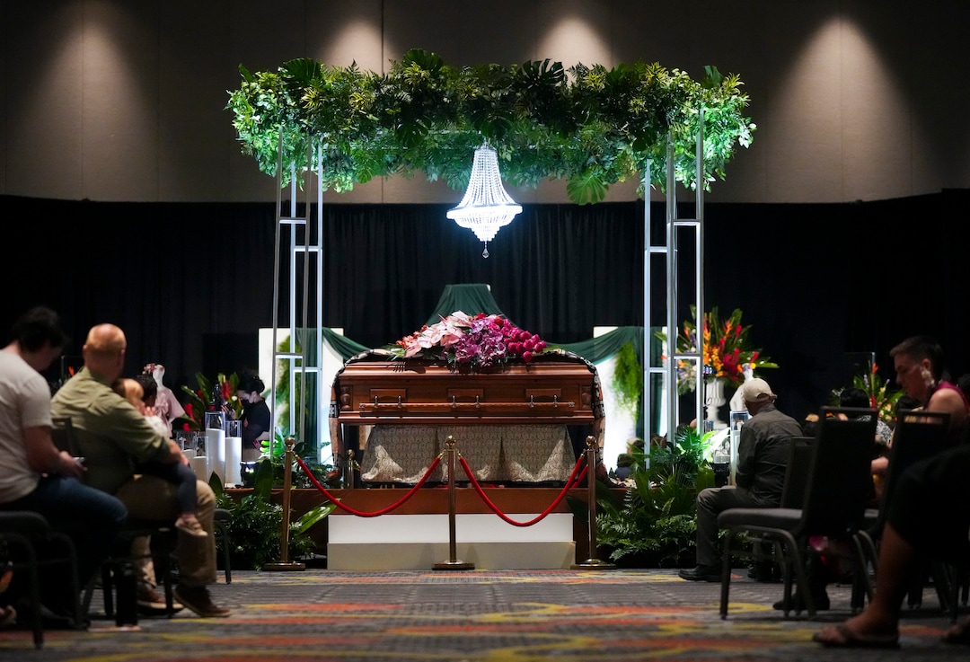 (Bethany Baker  |  The Salt Lake Tribune) The casket sits in the middle of the grand ballroom during the celebration of life for Afa Ah Loo, the man shot and killed during the 'No Kings' protest, during the community event at the Salt Palace Convention Center in Salt Lake City on Friday, June 27, 2025.