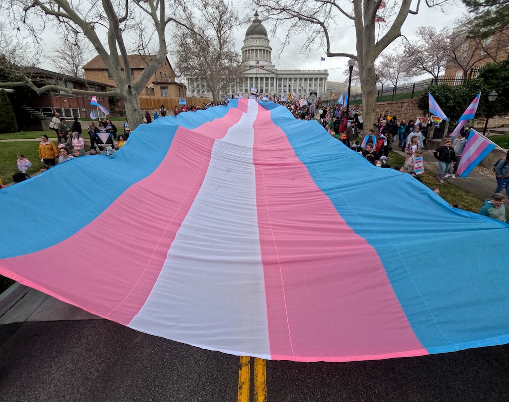 (Francisco Kjolseth | The Salt Lake Tribune) Hundreds of people show up at the Utah State Capitol on Mar. 29, 2025, to fly the largest transgender pride flag in Utah. The unveiling of the flag was part of celebrations for Transgender Day of Visibility, hosted by local nonprofits Utah Pride Center and The Glitter Foundation.